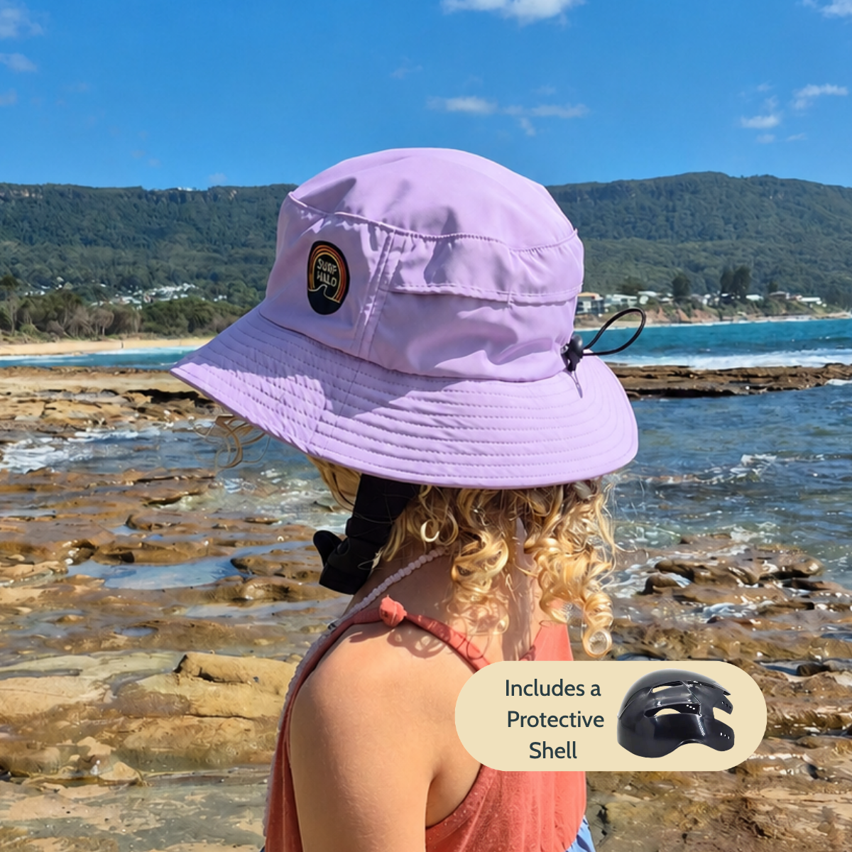 girl wearing surf hat  helmet on the beach lilac color 