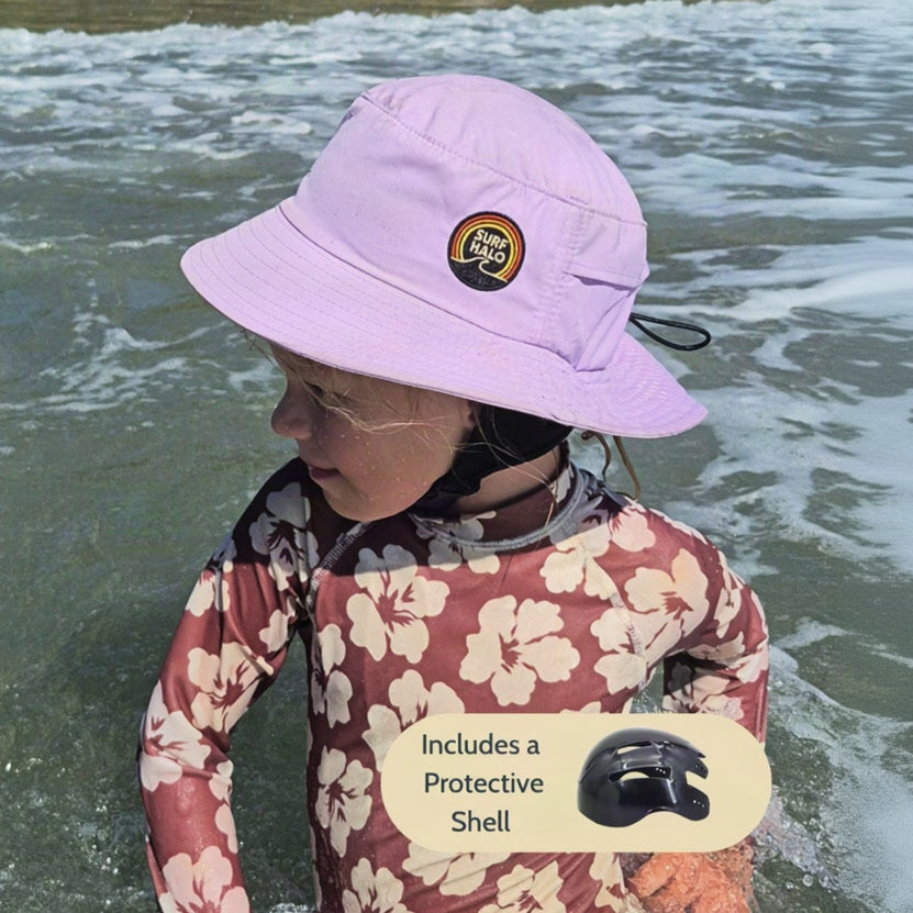 girl using a surf hat bucket hat helmet lilac in the beach while swimming 