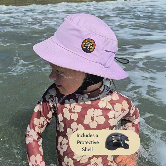 girl using a surf hat bucket hat helmet lilac in the beach while swimming 