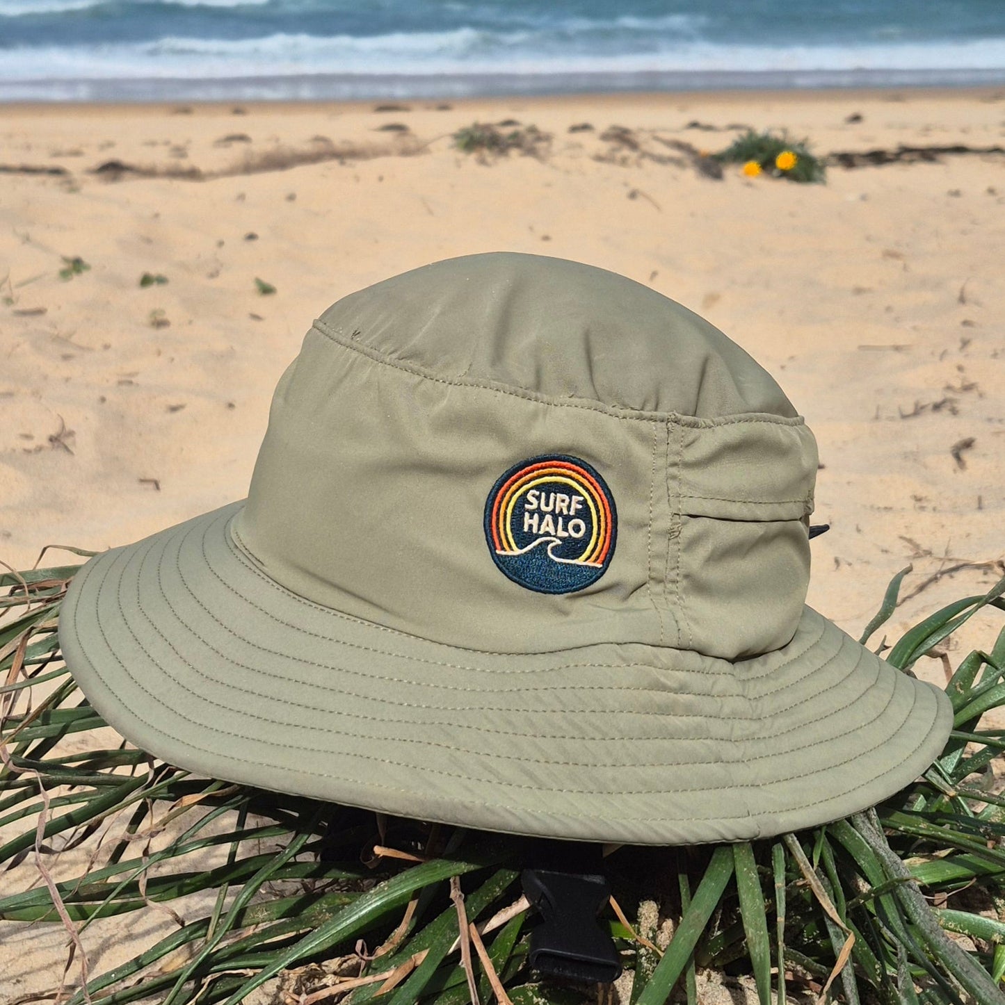 Green kids Surf Hat wide brim on a beach