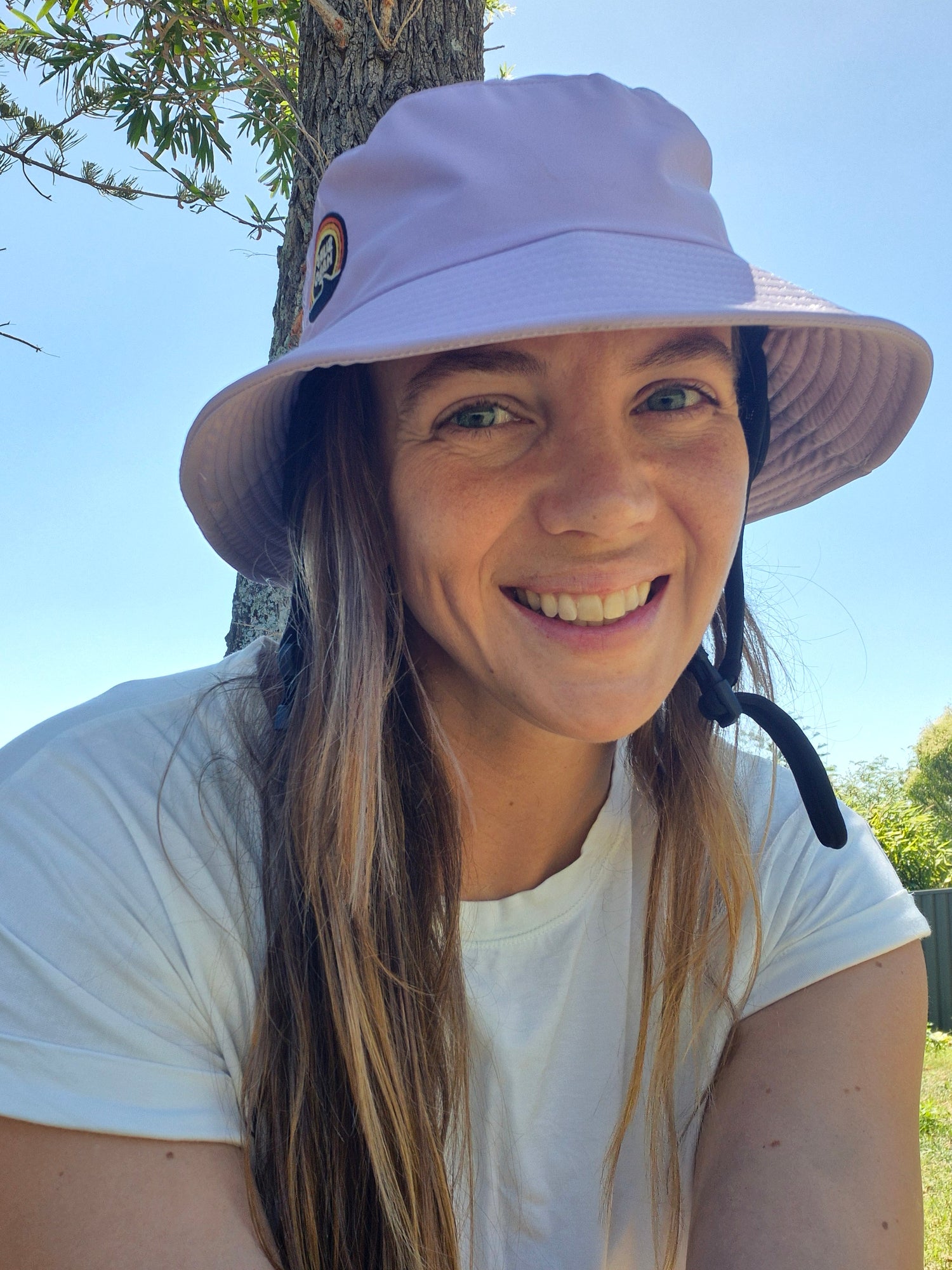 Surf halo founder wearing a pink surf helmet 