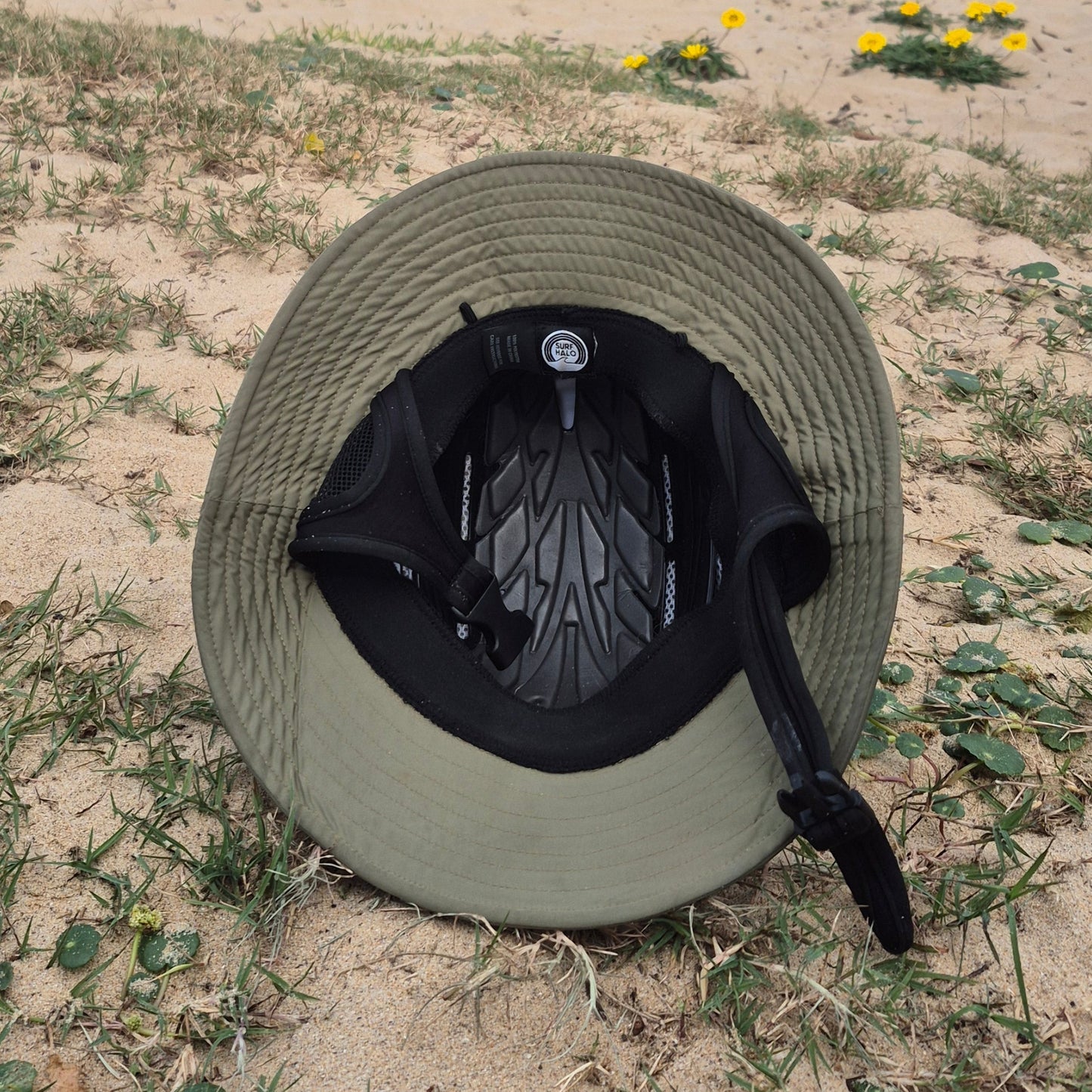 Inner view of a surf protective hat helmet on the sand