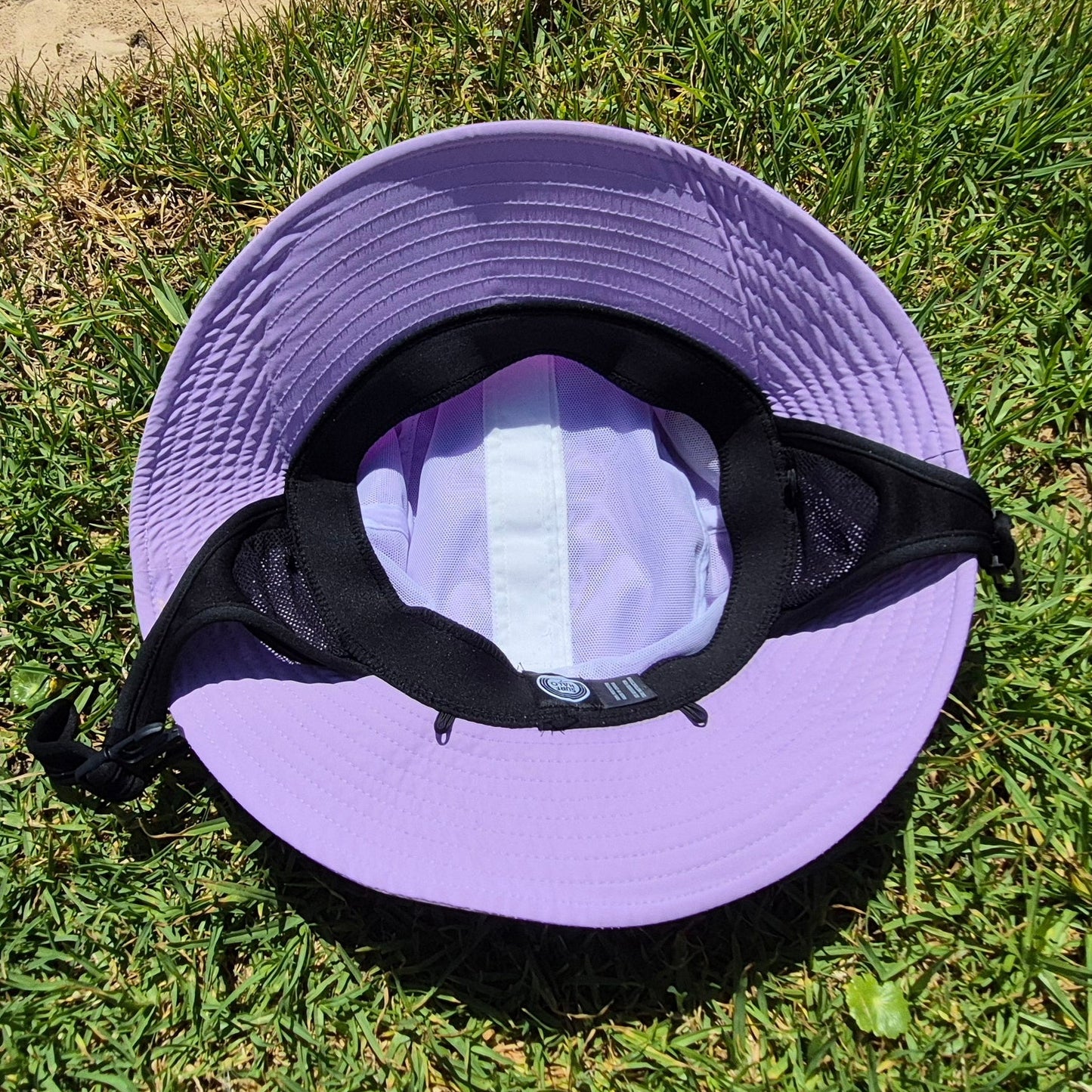 Pink bucket hat on grass inside view
